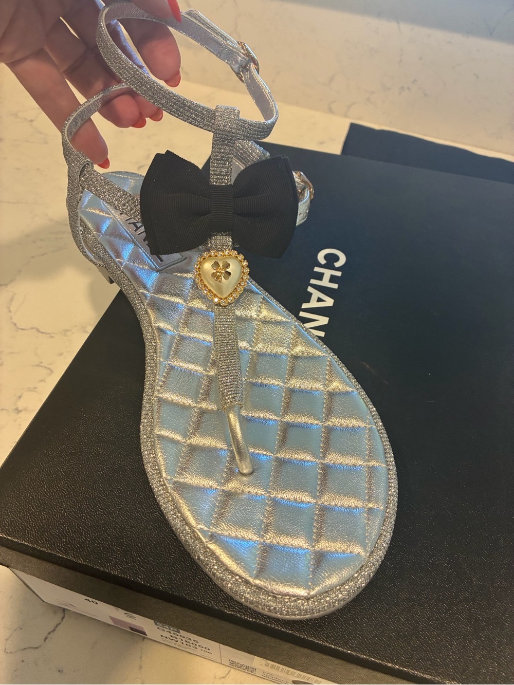 CHANEL Silver Quilted T-Strap Sandals with Black Bow